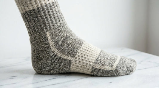 Close-up of a boot sock with visible knit-in arch support band and engineered compression zones