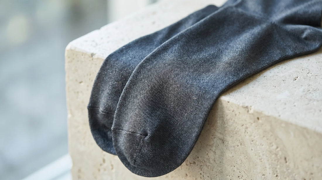 Sleek premium nylon-blend socks with a smooth sheen on a light surface