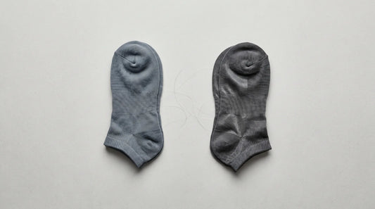 Two pairs of premium athletic socks compared side by side on a light surface