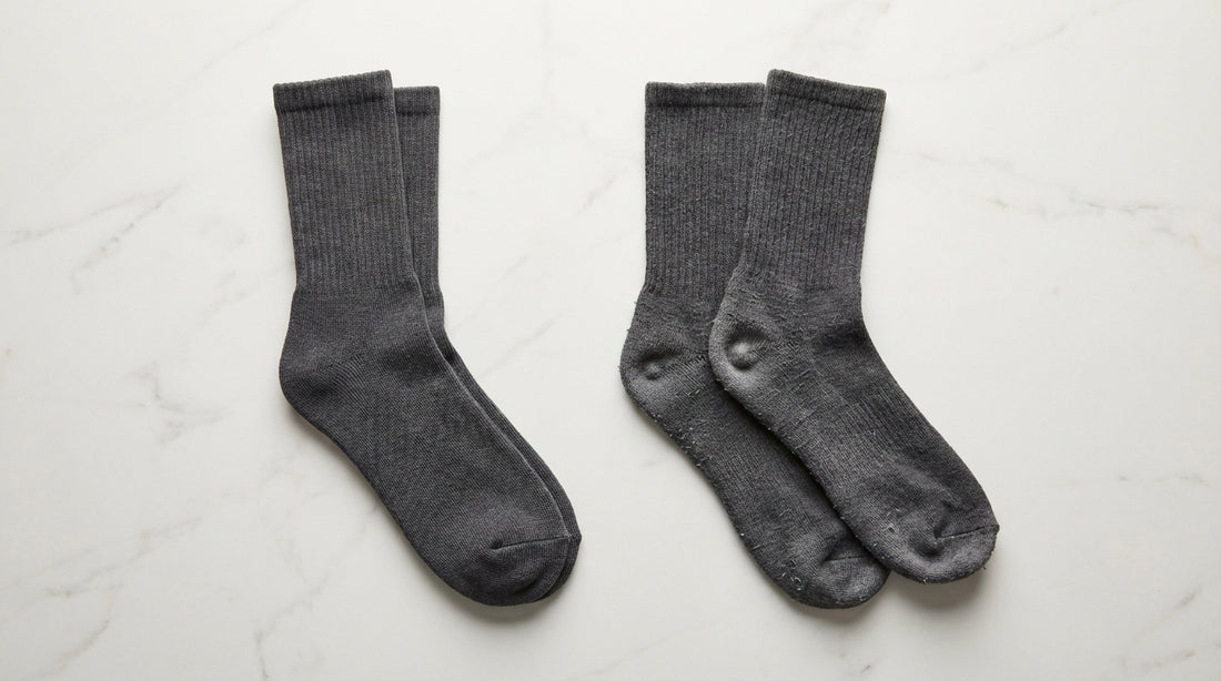 Comparison of a new sock pair versus a worn pair side-by-side showing visible wear differences