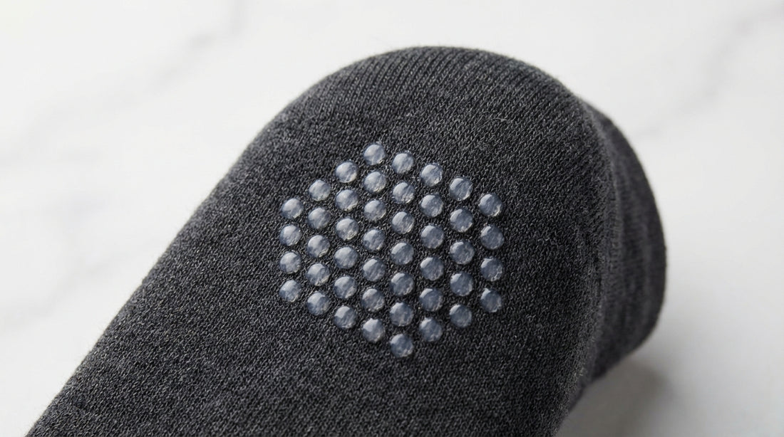 Close-up of silicone grip dots on the interior heel of a premium dress sock