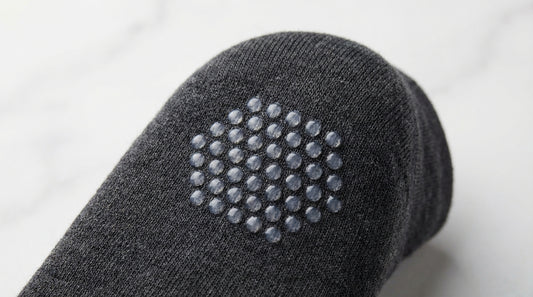 Close-up of silicone grip dots on the interior heel of a premium dress sock