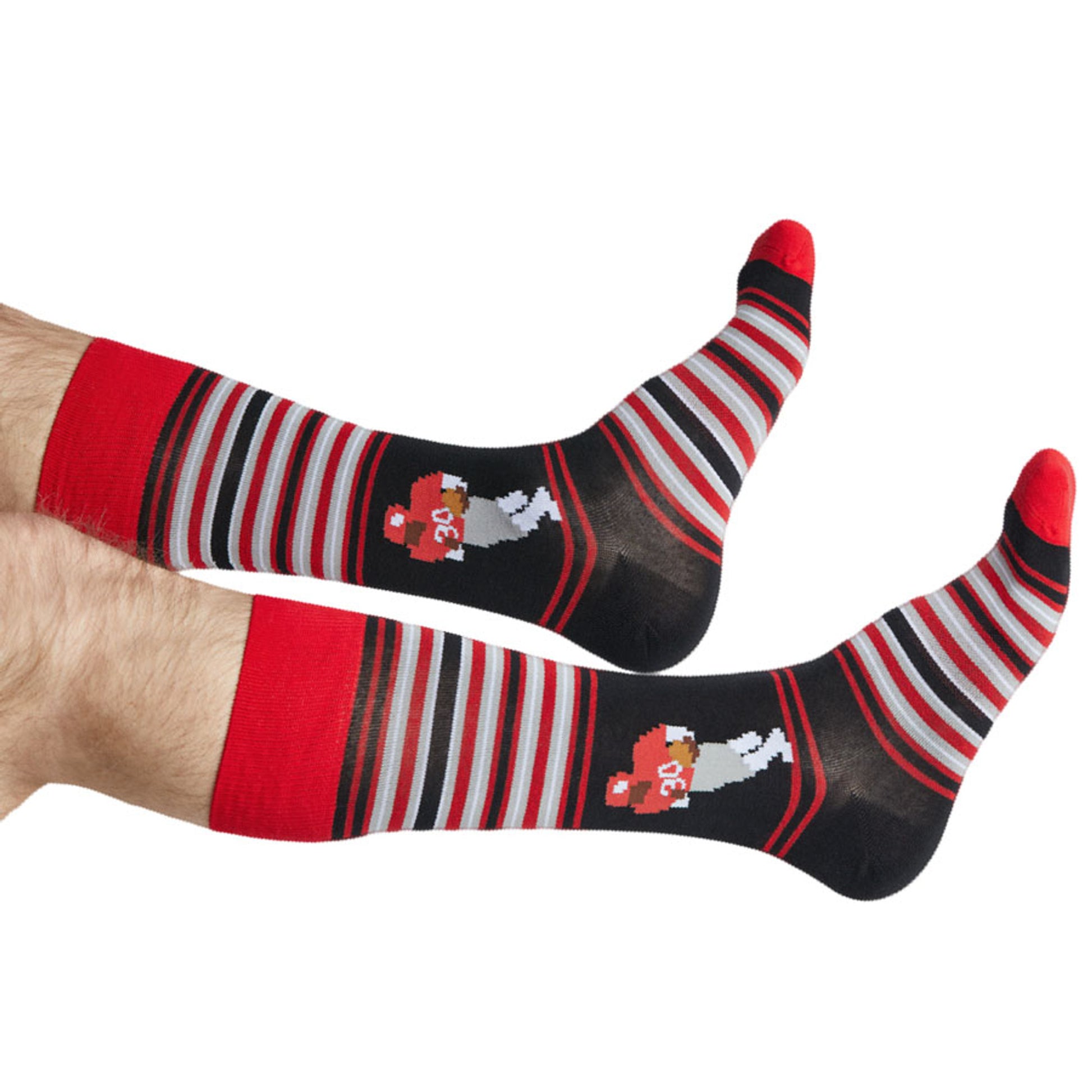 Red and black stripe dress socks with 8-Bit Hershel planting the flag on the ankle shown on legs coming into the left side of the image