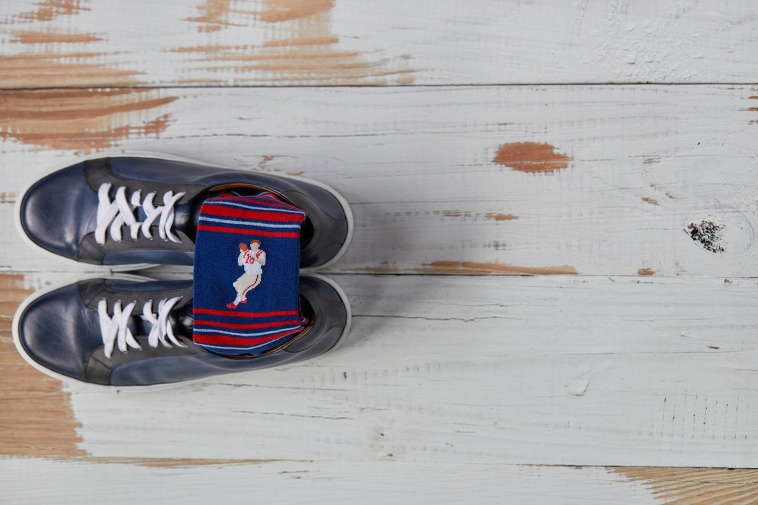 shot of the detail in the stitch on 8-bit archie red and navy stripe socks inside a grey sneaker