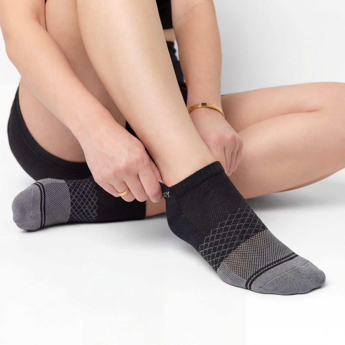 Black Socks ankle length on woman with breathable mesh in the top of the foot and arch support. 