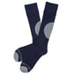 1 pair of navy dress socks lay flat crossed at the ankle with a large grey dot on the calf and a grey toe