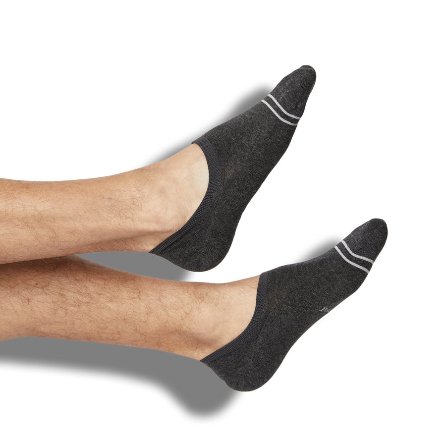 Beau no-show socks styled on a leg form, showing solid charcoal