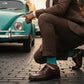 Beckett dress socks worn in an outdoor lifestyle scene with a brown striped pattern visible.