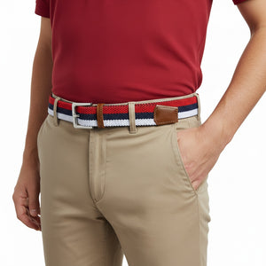 Person wearing a red shirt, beige pants, and a belt with a striped pattern on a white background