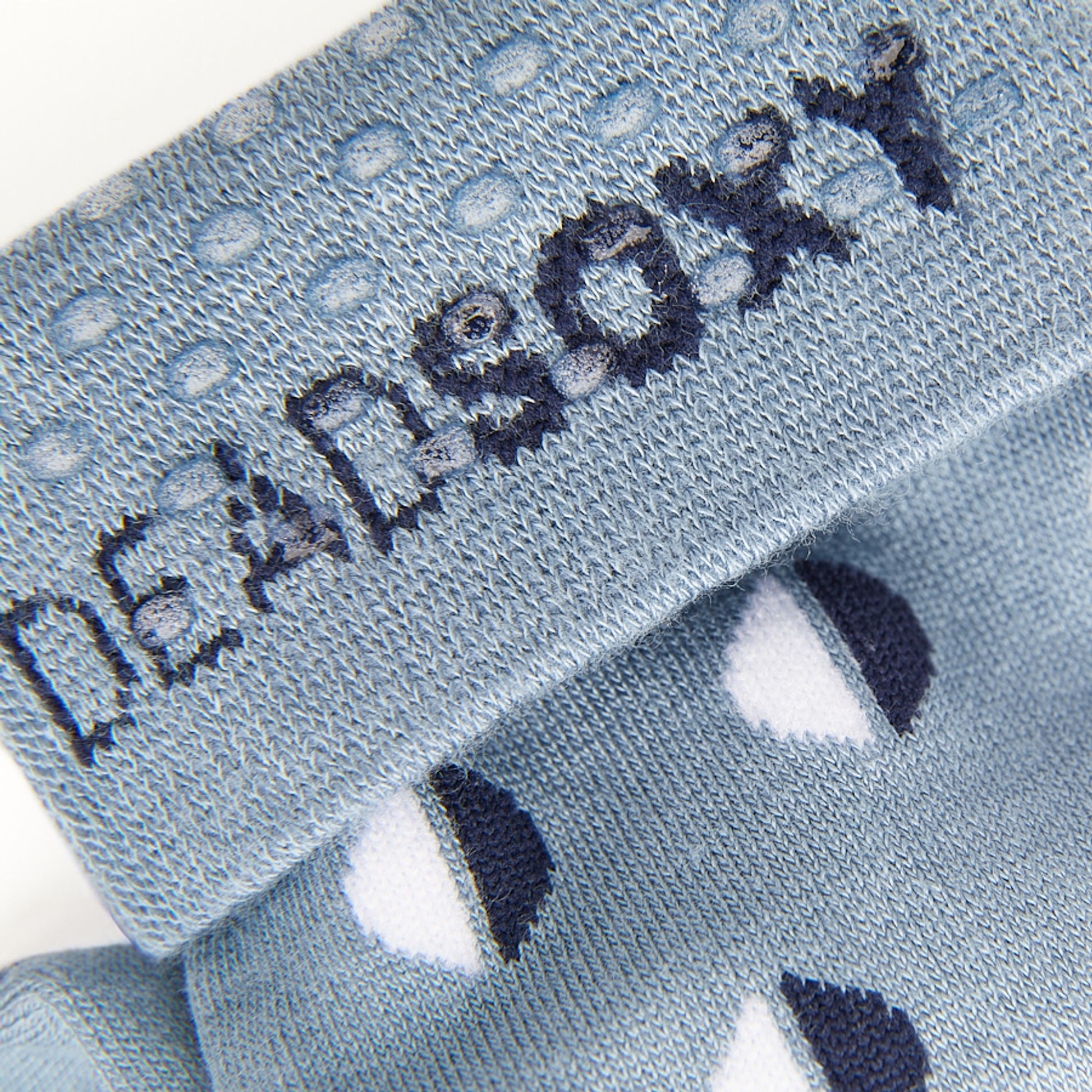 Close up view of light blue dress sock welt with TrueStay‚Ñ¢ silicone dots.
