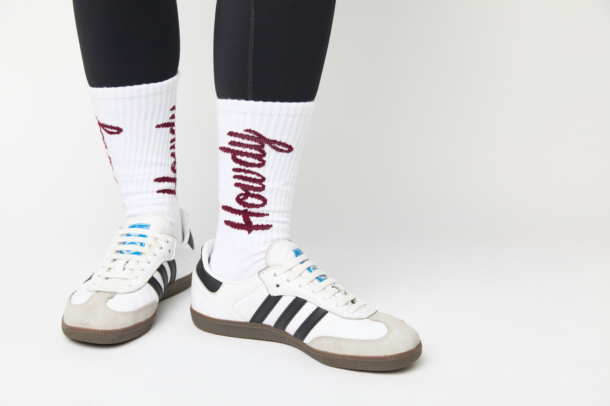 white casual crew socks with cushion and Howdy going up the leg on a woman in black leggings