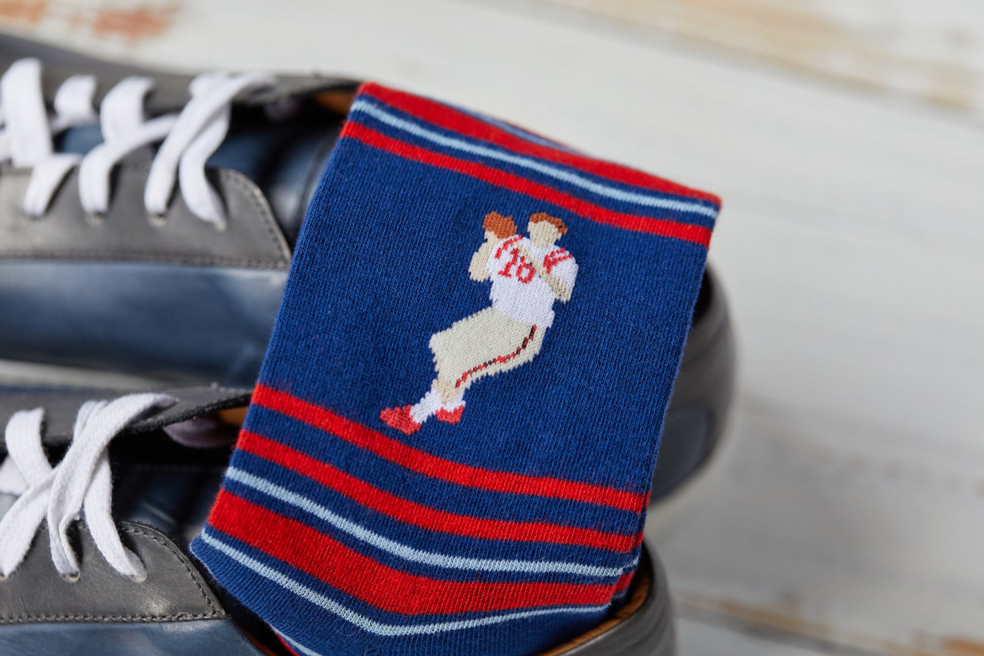 Close up of the detailing in the stitch of the 8-bit Archie red and navy stripe sock with #18 football player on the ankle