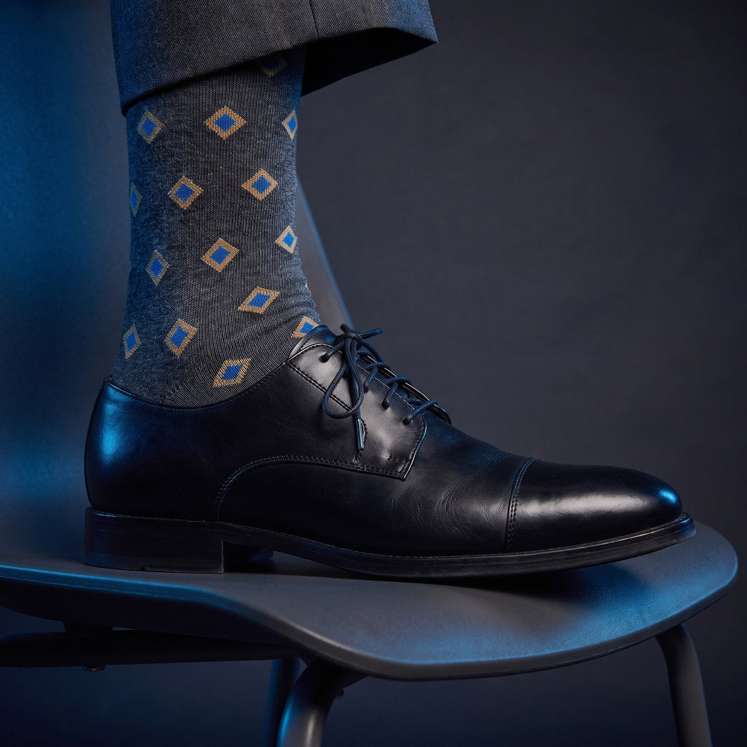 DeadSoxy Gerald cotton dress socks styled with dress shoes in a studio setting
