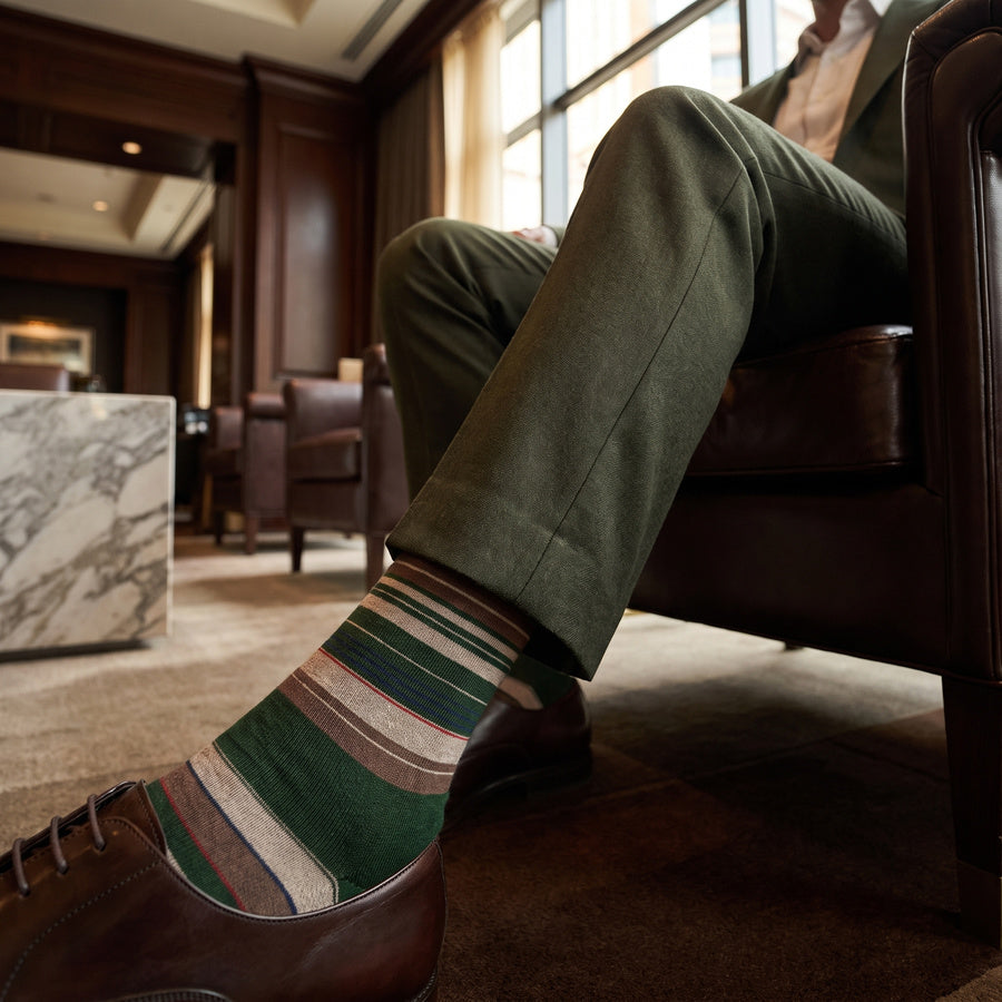 DeadSoxy Hayes cotton dress socks styled with dress shoes in a seated business setting