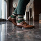 DeadSoxy Hayes cotton dress socks styled with dress shoes in a standing business setting