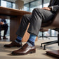 DeadSoxy Irving cotton dress socks styled with dress shoes in a seated business setting