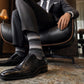 DeadSoxy Roman cotton dress socks styled with dress shoes in a seated business setting