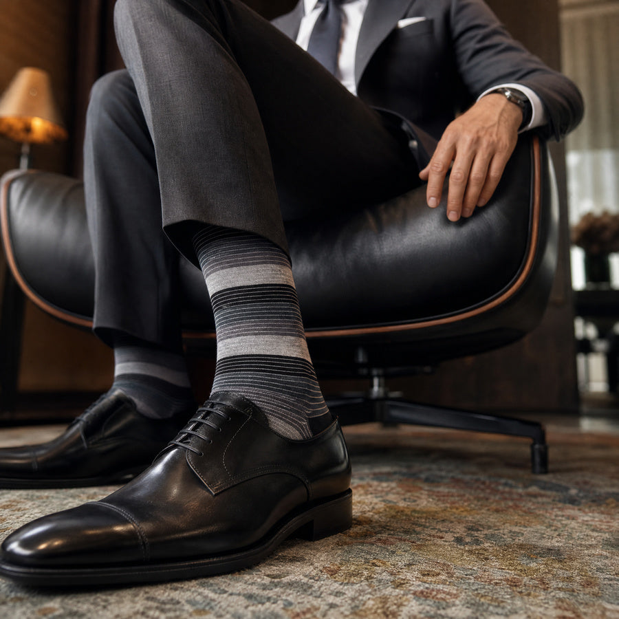DeadSoxy Roman cotton dress socks styled with dress shoes in a seated business setting