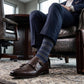 DeadSoxy Zane cotton dress socks styled with dress shoes in a seated business setting