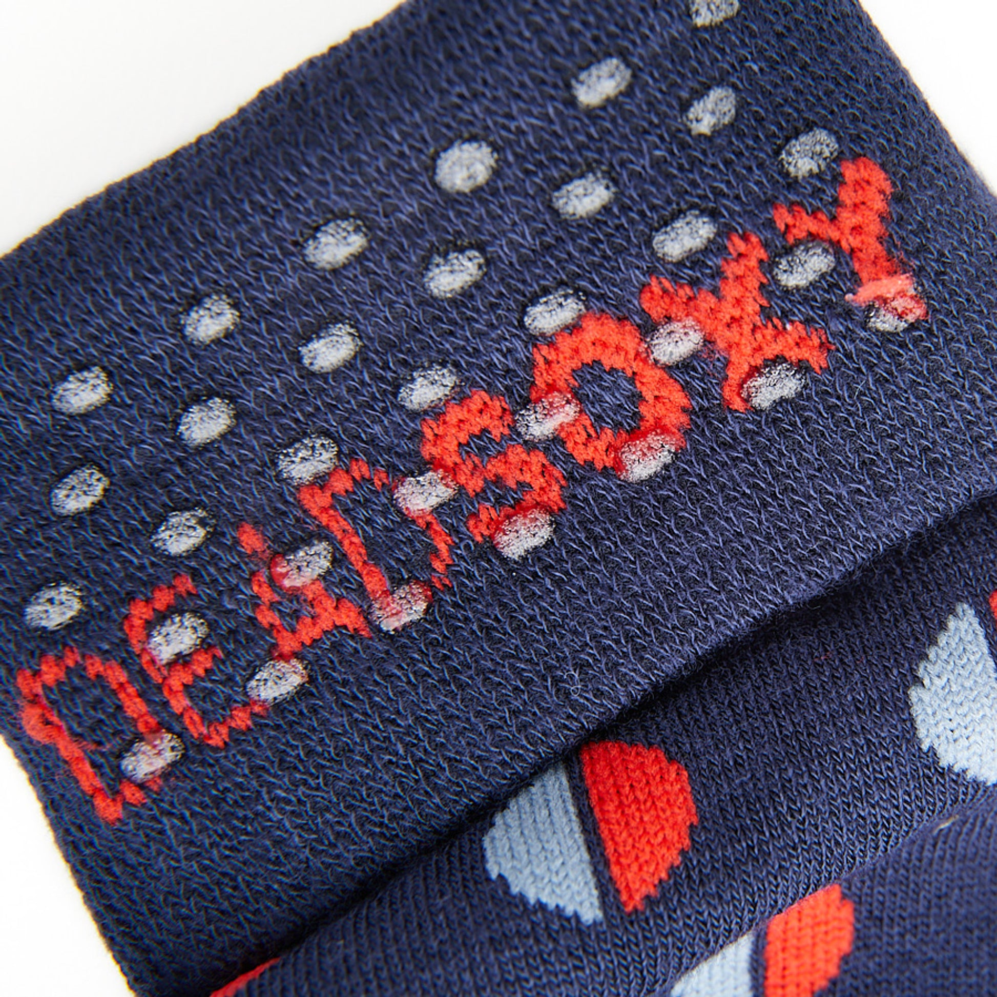 Close up view of navy blue dress sock welt with TrueStay‚Ñ¢ silicone dots.