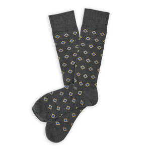 DeadSoxy Gerald Cotton Dress Socks flat lay showing a charcoal-gray base with blue diamonds outlined in yellow