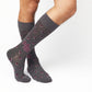 MSU Gray Cowbell Dress socks styled second angle, showing scattered maroon cowbells and the interlocking MSU logo on charcoal