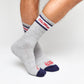 Grey casual crew socks with Ole Miss script on the leg and two retro stripes shown on legs.