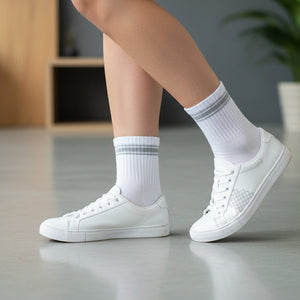 White and grey quarter crew socks styled with white sneakers in a casual lifestyle setting.