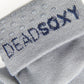 close up view of grey sock with navy writing in the welt and TrueStay‚Ñ¢ silicone dots