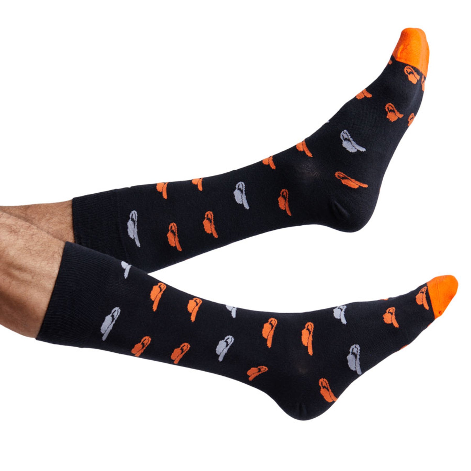 Orange and black Oklahoma dress socks with cowboy hats shown on feet coming into the image from the left.