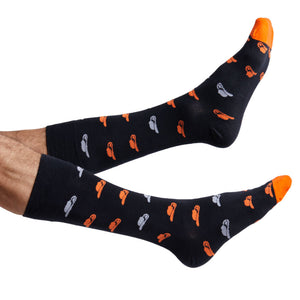 Orange and black Oklahoma dress socks with cowboy hats shown on feet coming into the image from the left.