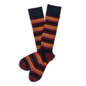 DeadSoxy Jasper Cotton Dress Socks flat lay showing warm red, orange and burgundy stripes on a dark base