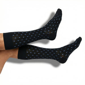DeadSoxy Lloyd dress socks in black with steel blue micro-motif pattern worn on foot