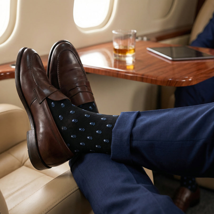 Lloyd black micro-pattern dress socks styled in travel setting