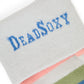 Close-up of DeadSoxy logo on light-grey TrueStay‚Ñ¢ cuff with silicone dots on Louie pastel striped sock.