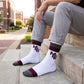 MSU Retro Stripe Casual socks worn without shoes, showing maroon and gray banding with the interlocking MSU logo on white