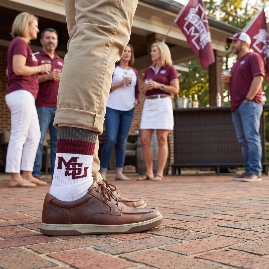 MSU Retro Stripe Casual socks worn standing on campus, showing maroon and gray banding with the interlocking MSU logo on white