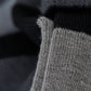 Close up macro image of yarn in monochrome dress socks showcasing a gradient of greys