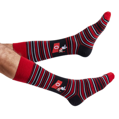 Crimson, black, and white striped socks with a small of Baker Mayfield planting the flag logo worn by a person on a white background