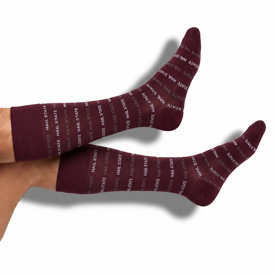 MSU Hail State Dress socks styled product shot, showing repeating HAIL STATE text in white and gray on maroon