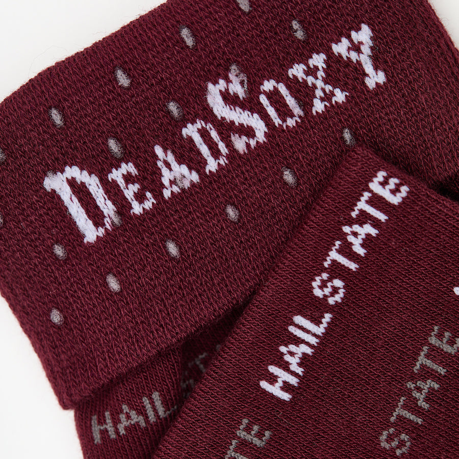 MSU Hail State Dress socks close welt and cuff detail, showing repeating HAIL STATE text in white and gray on maroon