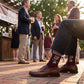 MSU Bulldawg Dress socks worn seated, second angle, showing the Bulldog mascot on maroon with gray colorblocking