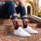 MSU Bulldawg Dress socks worn seated on campus, showing the Bulldog mascot on maroon with gray colorblocking