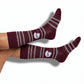 MSU Helmet Dress socks styled product shot, showing the State-script football helmet and fine striping on maroon