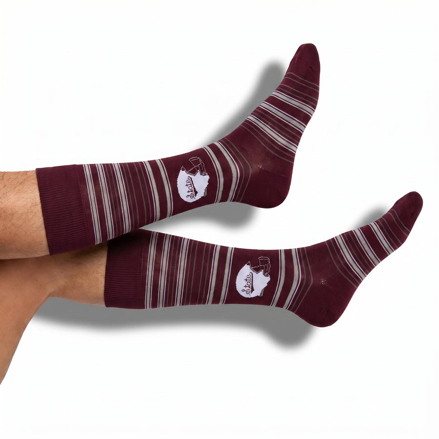 MSU Helmet Dress socks styled product shot, showing the State-script football helmet and fine striping on maroon