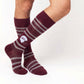 MSU Helmet Dress socks styled second angle, showing the State-script football helmet and fine striping on maroon