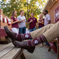 MSU Helmet Dress socks worn seated, second angle, showing the State-script football helmet and fine striping on maroon