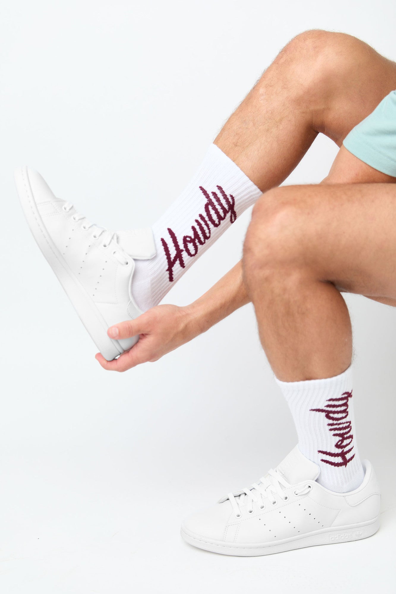 Maroon dress socks with Howdy written in script text in grey and white.
