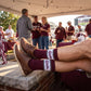 MSU Retro Script Casual socks worn seated, showing the State script on a white band across a maroon crew