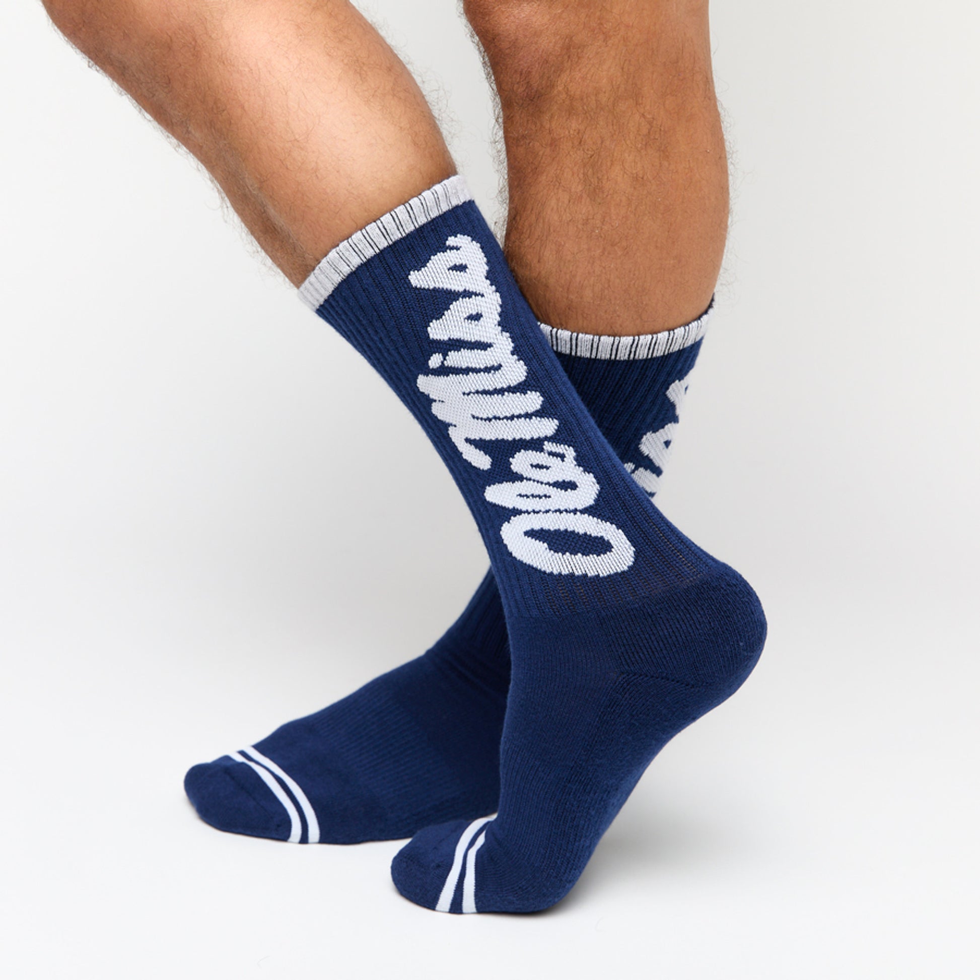 Navy casual crew socks with Ole Miss going up the leg in white.